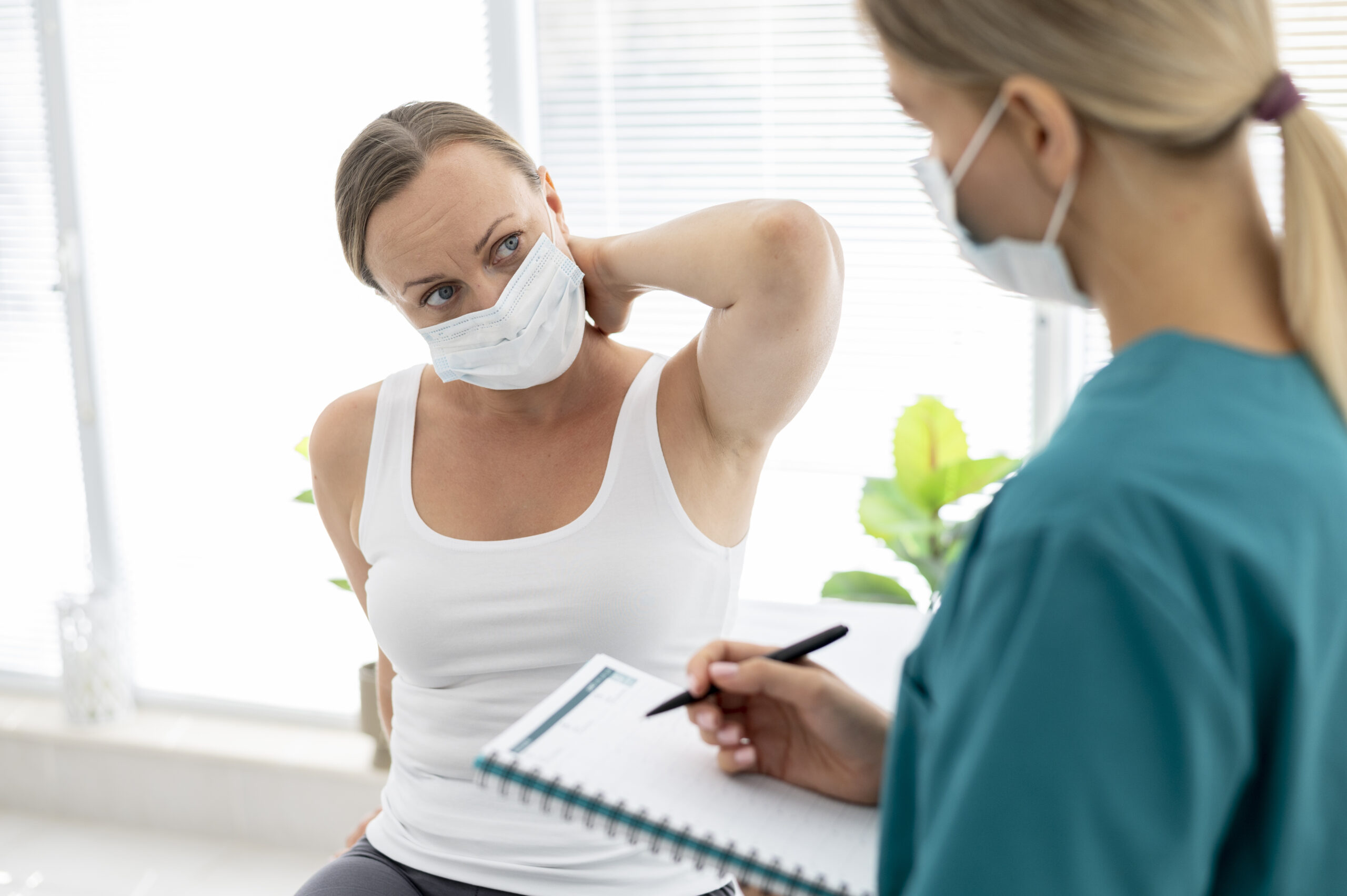 A patient waring a facemask attends a physiotherapy assessment