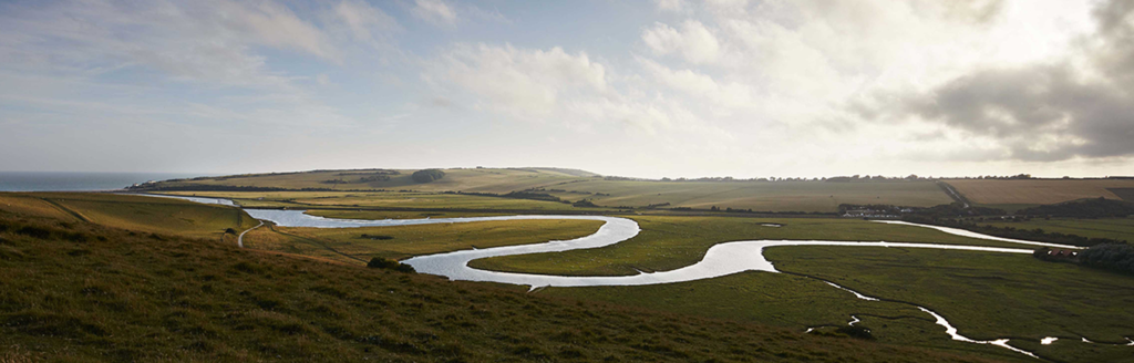 The Cuckmere river on a summers day. This is a visual banner to break up the page and does not contain any links.